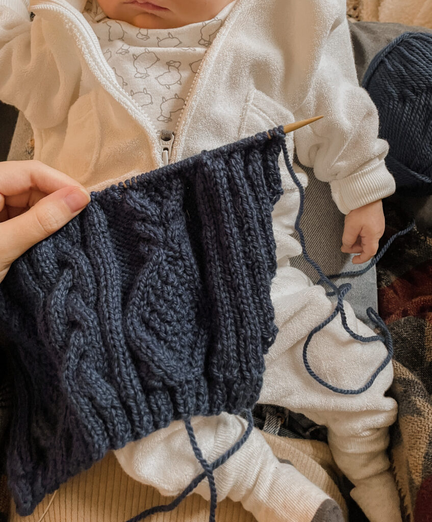 baby with knitted piece